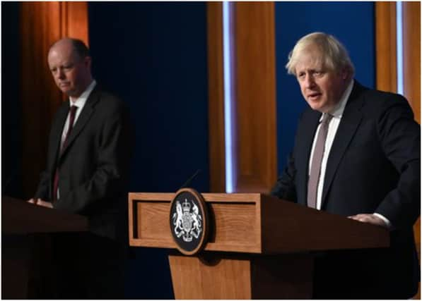 LONDON, ENGLAND - NOVEMBER 15: Prime Minister Boris Johnson standing next to British Chief Medical Officer for England Chris Whitty as he addresses the media regarding the United Kingdom's Covid-19 infection rate and vaccination campaign at Downing Street Briefing Room on November 15, 2021 in London, England. The prime minister and his advisers encouraged Britons to receive their Covid-19 vaccine booster when eligible. (Photo by Leon Neal - WPA Pool/Getty Images)