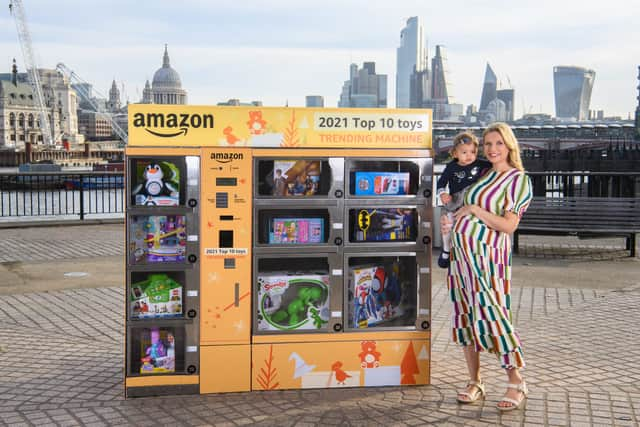 EDITORIAL USE ONLYRachel Riley and her daughter Maven unveil Amazon’s top ten toys for Christmas using the ‘Trending Machine’ at Observation Point, London. Picture date: Monday October 11, 2021. PA Photo. Amazon is touring the ‘Trending Machine’ around the UK in the run up to the festive period to give away this year’s most desirable toys, including Harry Potter Air Pictionary and the Polly Pocket Rainbow Funland Theme Park set, to passersby in city centres and children at local hospitals. Photo credit should read: Matt Crossick/PA Wire