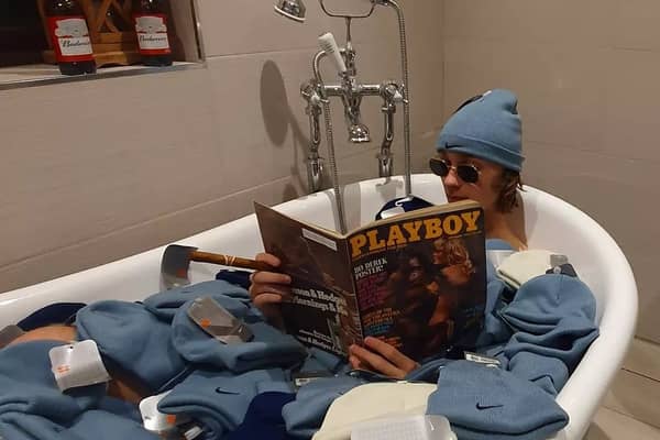 Depop entrepreneur Callum Massey poses in a bath full of deadstock nike beanies from 2002 that he purchased and resold on the site. 