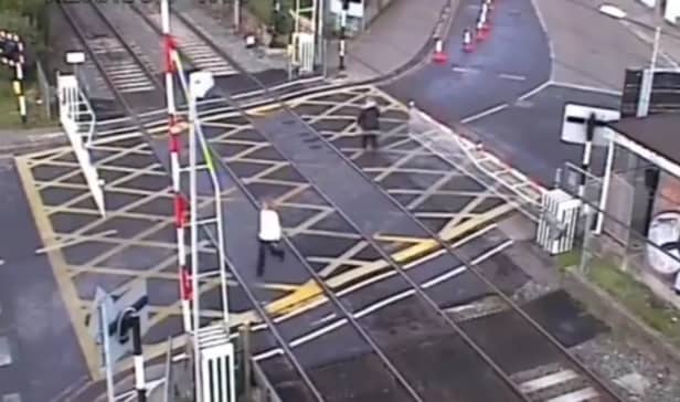 Woman crushed by level crossing barrier.