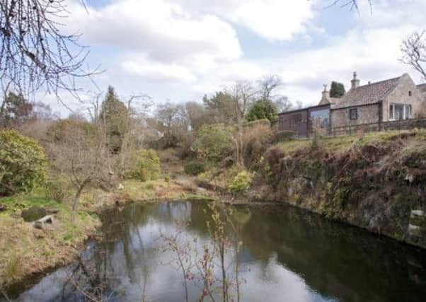 The house and garden acrossed the flooded quarry. Picture: Contributed