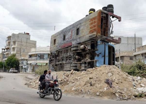 Destroyed buses are piled up on rubble in the northern city of Aleppo, where violence has also continued. Picture: Getty