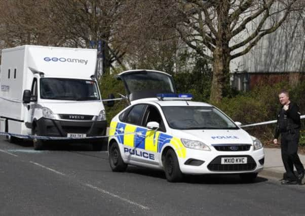 A police officer stands guard at the crime scene where two men escaped from a prison van. Picture: PA