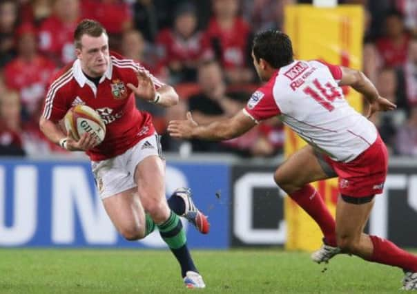 Stuart Hogg takes on Rod Davies during yesterday's day against Queensland Reds. Picture: Getty