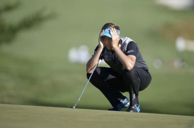 Ian Poulter of England lines up a putt on the 18th green during a continuation of the second round of the US Open. Picture: Getty