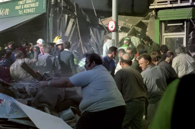 People dig with their bare hands in the aftermath of a bomb in the Shankhill Road, Belfast. Picture: PA