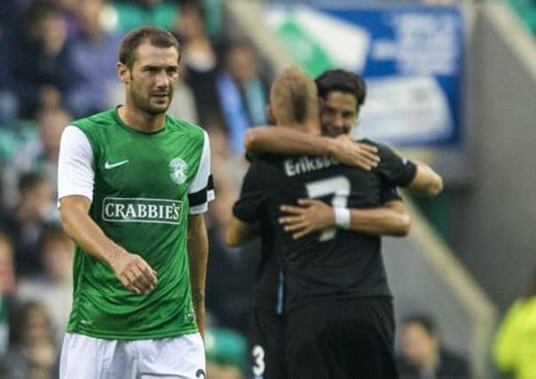 Kevin Thomson looks on as Malmo players celebrate their third goal. Picture: SNS