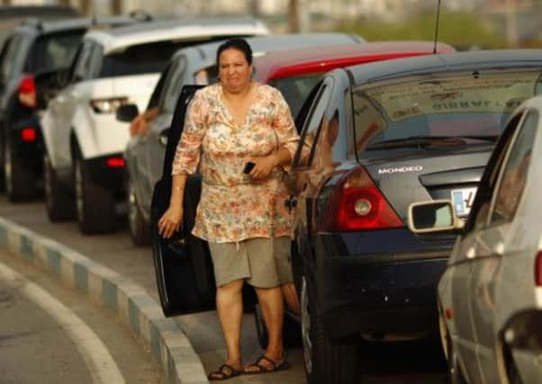 A woman reacts as she waits in line to enter Gibraltar at its border with Spain. Picture: Reuters