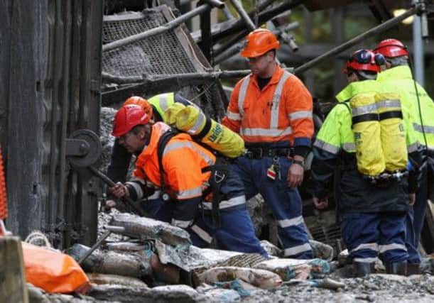 Workers clear debris from the mine entrance during a failed re-entry attempt in 2011. Picture: Getty