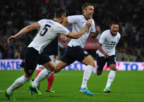 Englands Rickie Lambert races away to celebrate scoring the winning goal in Englands 3-2 victory over Scotland. Picture: AFP/Getty