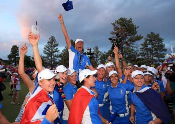 Liselotte Neumann of Sweden the European Team captain is held aloft. Picture: Getty