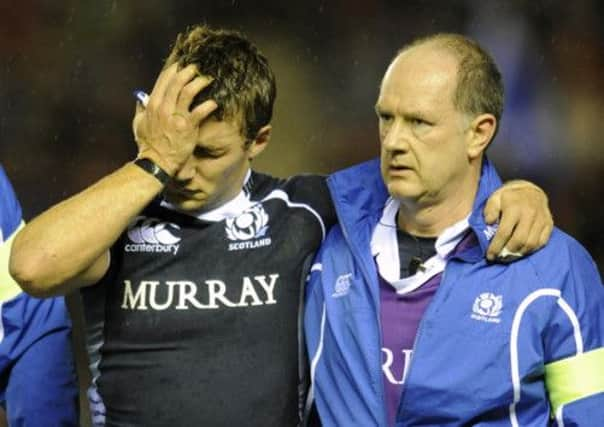 Dr James Robson leads Scotland's Chris Cusiter from the field in a 2009 Test match. Picture: Ian Rutherford