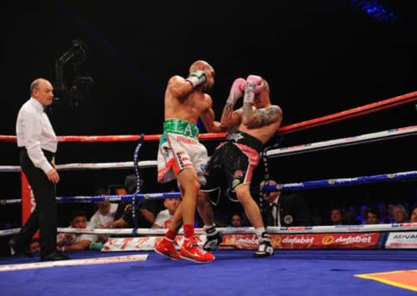 Carlos Beltran pummels Ricky Burns during their WBO Lightweight title fight. Picture: Robert Perry