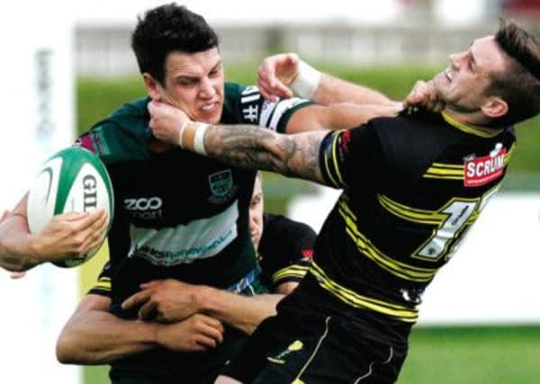 Smash and grab:  Melroses Mark Robertson, right, puts in a tackle as his side overturned a half-time deficit. Photograph: Toby Williams