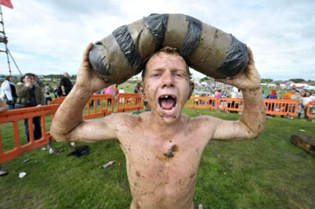 Jordan Gray with his prize for climbing the greasy pole. Picture: Donald MacLeod