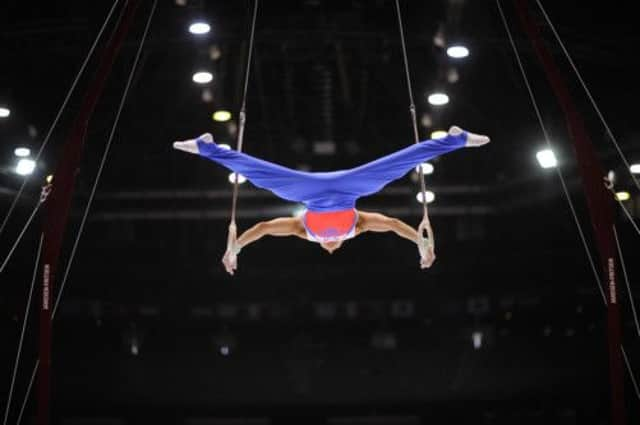 Russias David Belyavskiy during qualification on the rings at the world championships. Picture: AFP/Getty