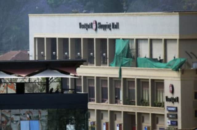 Kenyan security forces stand on the top floor of a building facing the Westgate Mall in Nairobi. Picture: AP