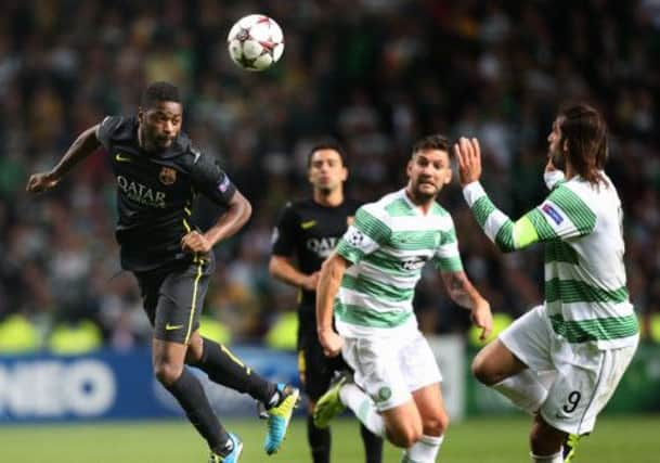 Celtic's Giorgos Samaras challenges for the ball with Barcelona's Alex Song. Picture: AP