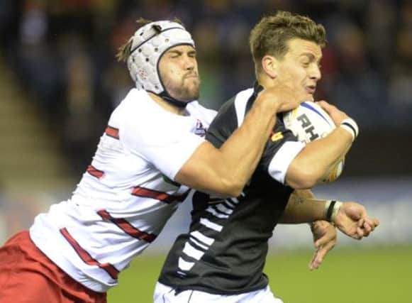 Edinburgh's Izak van der Westhuizen (left) tackles Tommaso Iannone. Picture: SNS