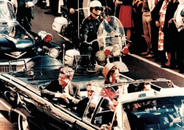 Crowds in Dallas watch John F Kennedy and wife Jackie pass by on 22 November 1963. Picture: Contributed