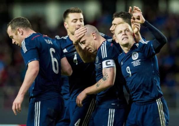 Steven Naismith hails the fans as Robert Snodgrass and Russell Martin, left, congratulate scorer Scott Brown. Picture: SNS