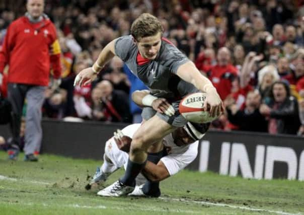 Welsh debutant Hallam Amos is tackled by Tonga's Siale Piutau. Picture: PA