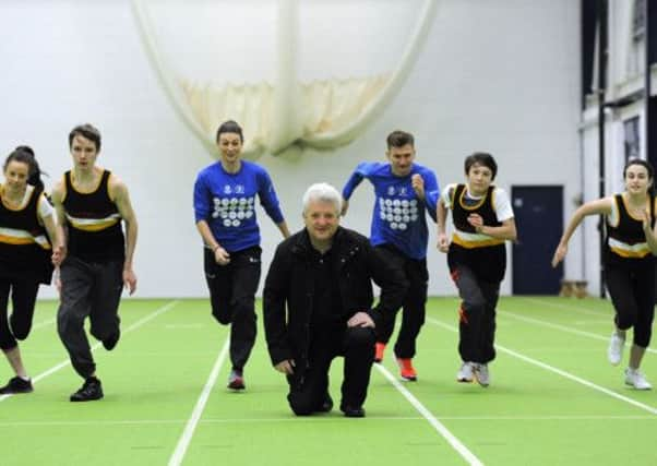 Stephen Maguire flanked by Sarah Warnock and Derek Hawkins, along with Kilmarnock Academy pupils. Picture: Mike Scott