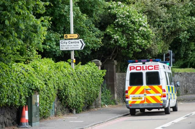 Police at the scene of the murder. Picture: TSPL