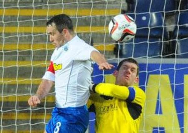 Goalscorer Dougie Imrie fouls Bairns keeper Michael McGovern. Photograph: Robert Perry