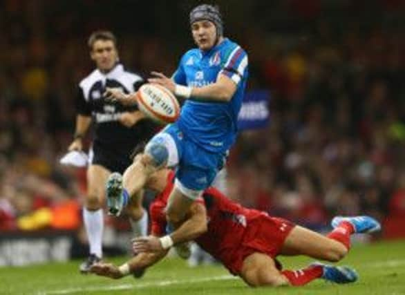 Italys Michele Campagnaro kicks ahead as Mike Phillips is just too late with the tackle. Picture: Getty