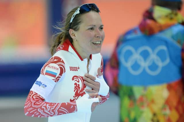 Olga Graf covers her modesty after forgetting she wearing nothing under her suit. Picture: AFP/Getty