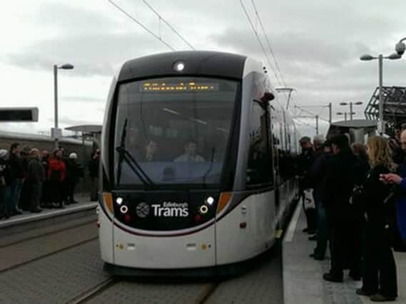 Pioneer passengers wave down a tram outside Murrayfield stadium yesterday.  Picture: Greg Macvean