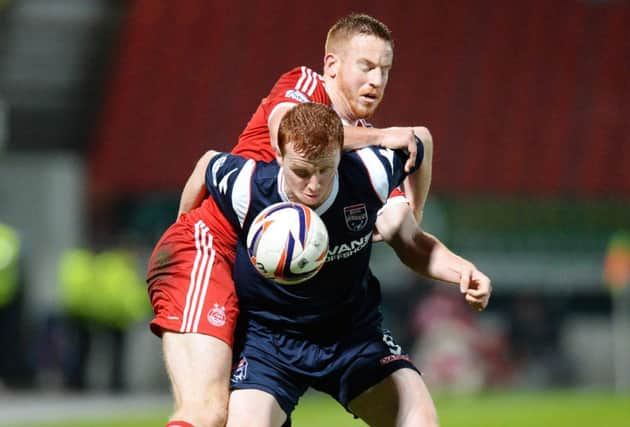 Aberdeen's Adam Rooney (left) tussles with Scott Boyd. Picture: SNS