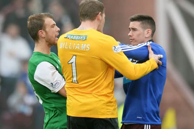 Hearts Jamie Walker, right, becomes embroiled with Ben Williams and Jordan Forster at full-time. Picture: SNS