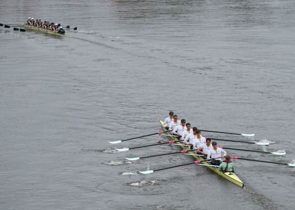 Oxfords crew celebrate in style with a large bottle of Bollinger champagne. Picture: AP Photo