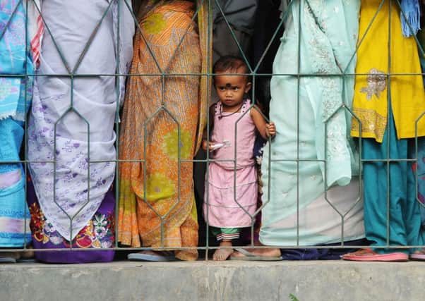 People wait at a polling station in Dibrugarh, north-east India yesterday, as voting begins in parliamentary elections. Picture: AFP/Getty