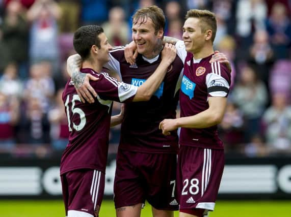 Ryan Stevenson (centre) celebrates his second with team-mates Sam Nicholson (right) and Jason Holt. Picture: SNS