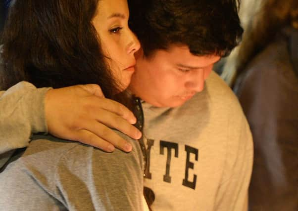 Students comfort each other during a candlelight vigil for the victims. Picture: Getty