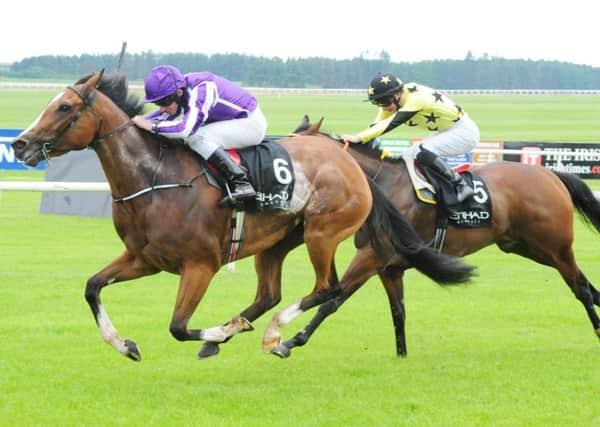 Marvellous (left), ridden by Ryan Moore, wins the Etihad Airways Irish 1000 Guineas. Picture: PA