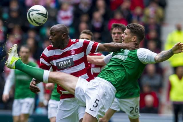 Hamilton's Jason Scotland grapples with Michael Nelson of Hibernian. Picture: SNS