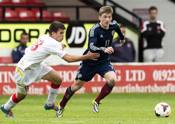 Ryan Gauld (right) keeps the ball under pressure from Nikola Vujnovic. Picture: SNS