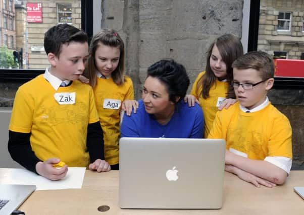 Our Ladies High School, Motherwell pupils Zak Docherty, Agnieszka Poslednik, Wiktoria Debrowska and Stephen Black with Apple's Jemma.Picture: TSPL