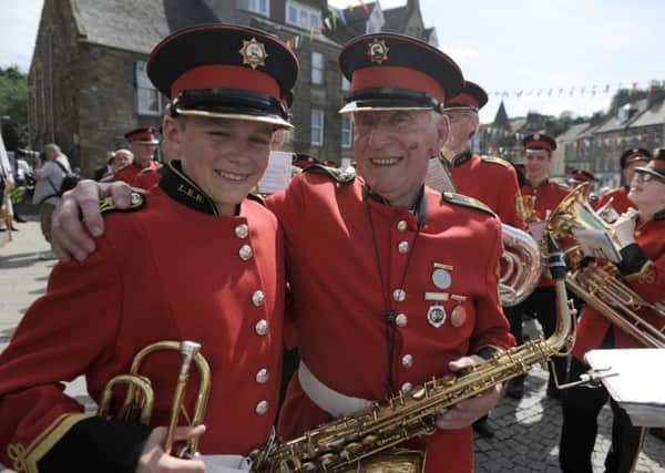 Linlithgow Marches. Youngest and oldest member of Linlithgow Pipe Band. Eddie McKenna (83) and Peter Molloy (12). Picture: Contributed