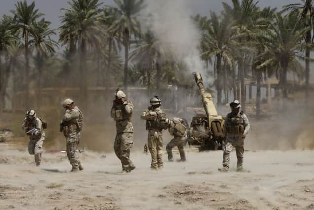 Soldiers fire artillery during clashes with Sunni militant group Isis. Picture: Reuters