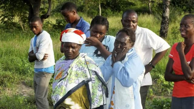 Residents mourn relatives who were killed when gunmen attacked Hindi village. Picture: Reuters