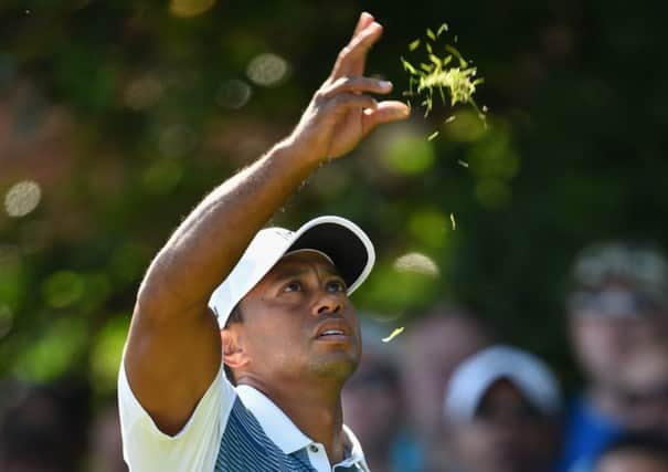 Tiger Woods tests the wind at the fifth hole during yesterdays first round at Hoylake. Picture: Getty