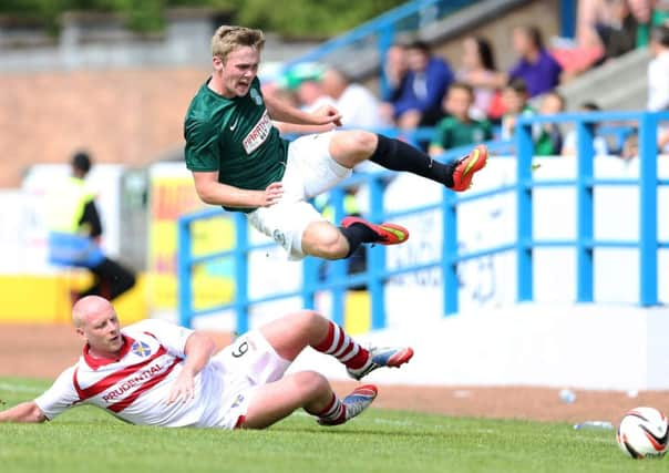 Hibs Lewis Allen flies through the air following a challenge by Chris Smith of Stirling Albion yesterday. Picture: Getty Images