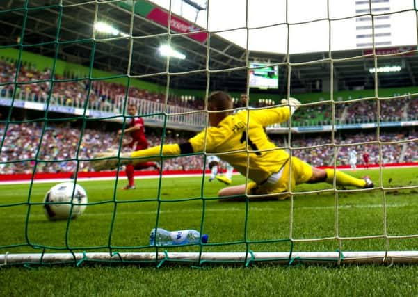 Niall McGinn (left) fires the ball by FC Groningen keeper Sergio Padt. Picture: SNS