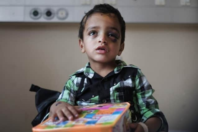 A Palestinian boy receives a present for the Eid al-Fitr holiday, at the Shifa hospital in Gaza, where he is hospitalized. Picture: AP