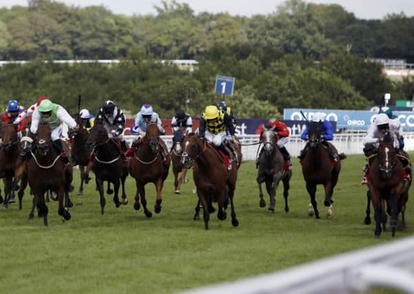 Intrinsic (right) ridden by Richard Hughes wins the 32Red Cup. Picture: PA